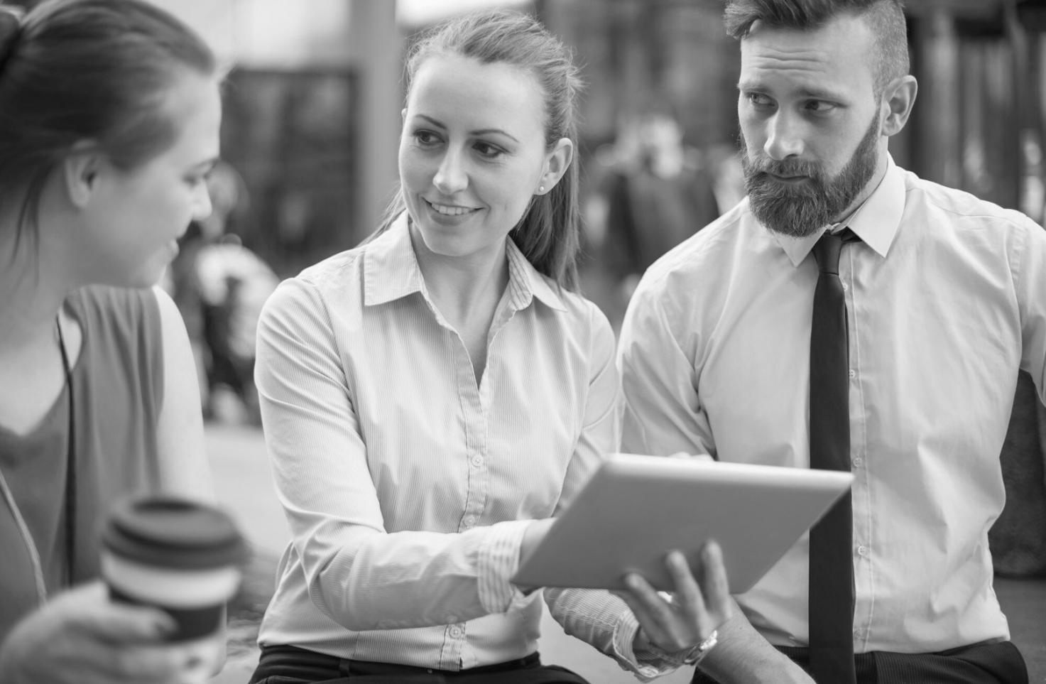 Professional financial consultant reviewing market data and trends on multiple screens